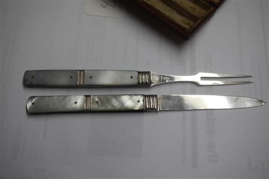 A cased Georgian silver and mother of pearl folding travelling fruit knife and fork,